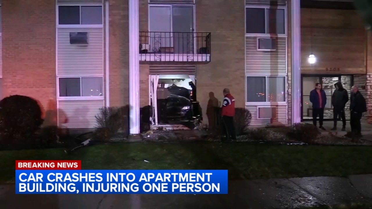 1 injured when car crashes into suburban apartment building