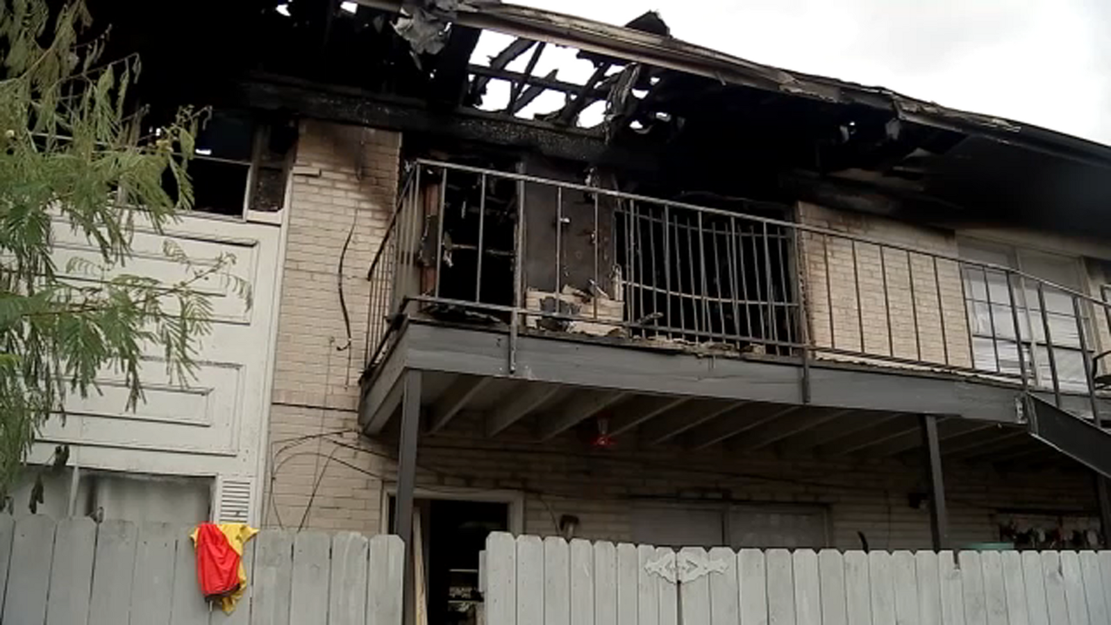 1 person in custody after man rescued from burning apartments on