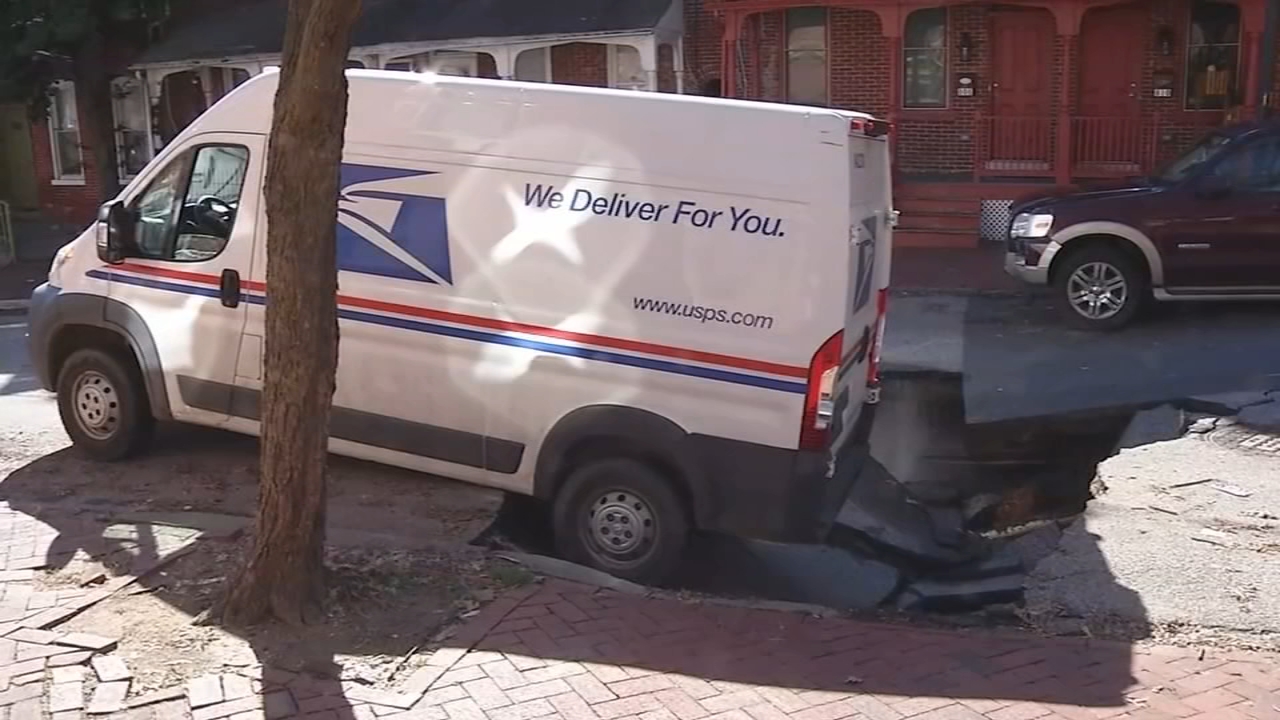 Mail truck partially swallowed up by sinkhole on Wilmington, Delaware street