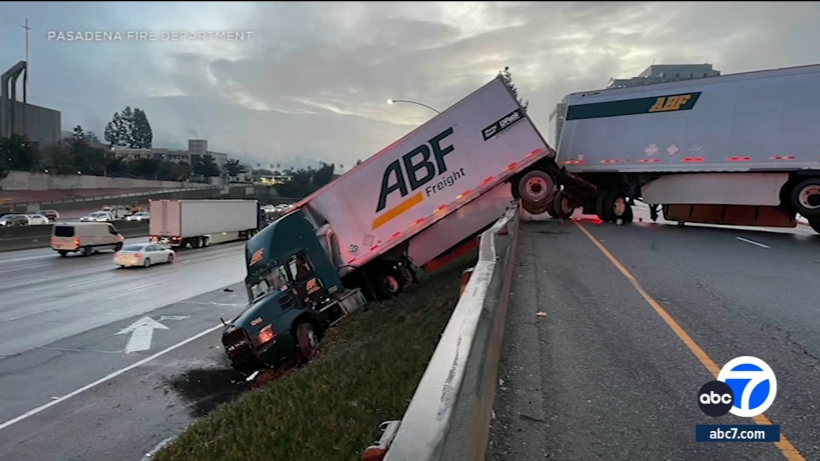 Jackknifed semitruck leaves cab dangling down embankment in Pasadena