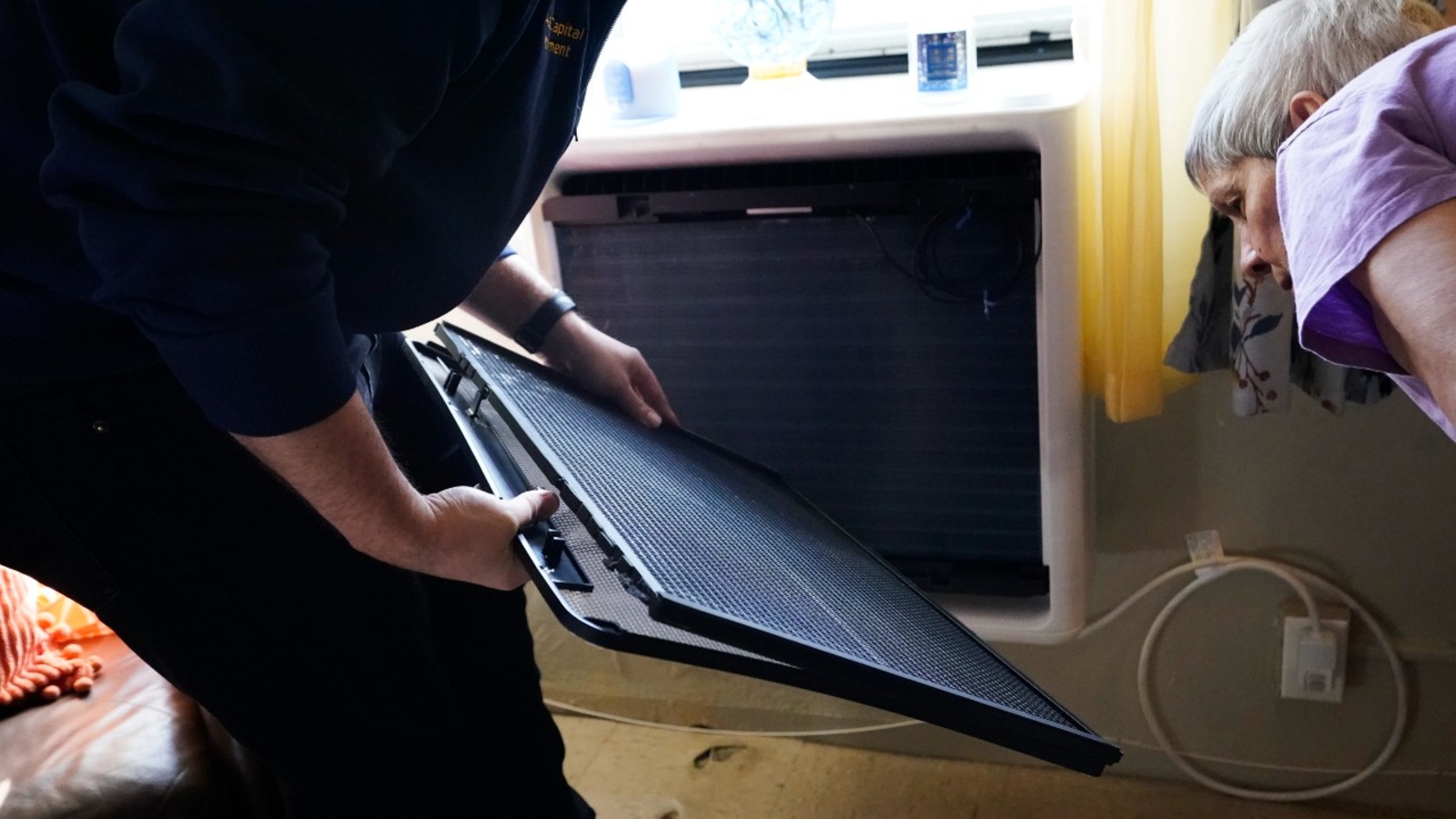 NYCHA is testing heat pumps that fit in an apartment windows in efforts