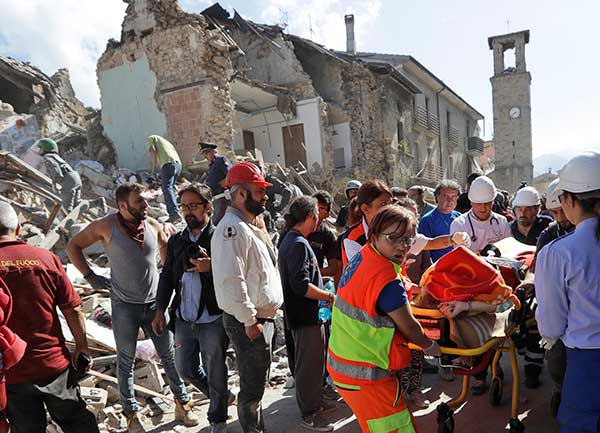 A victim is pulled out of the rubble following an earthquake in Amatrice Italy, Wednesday, Aug. 24, 2016.
