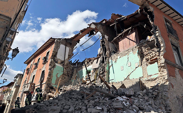 Firefighters search amid the rubbles of a collapsed building in Amatrice Italy, Wednesday, Aug. 24, 2016,