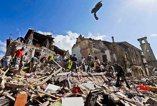 Rescuers search amid rubble following an earthquake in Amatrice Italy, Wednesday, Aug. 24, 2016.