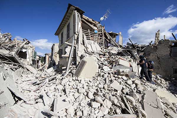 Rescuers search for survivors under the rubble of the town of Amatrice, central Italy, Wednesday, Aug. 24, 2016 following an earthquake.