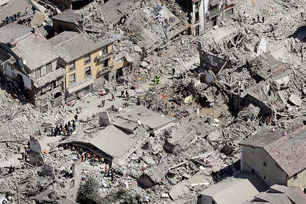 Rescuers search amid rubble following an earthquake in Amatrice Italy, Wednesday, Aug. 24, 2016.