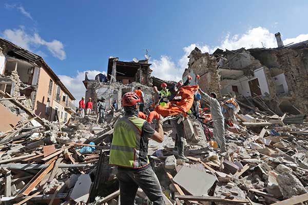 Rescuers search for survivors under the rubble of the town of Amatrice, central Italy, Wednesday, Aug. 24, 2016.