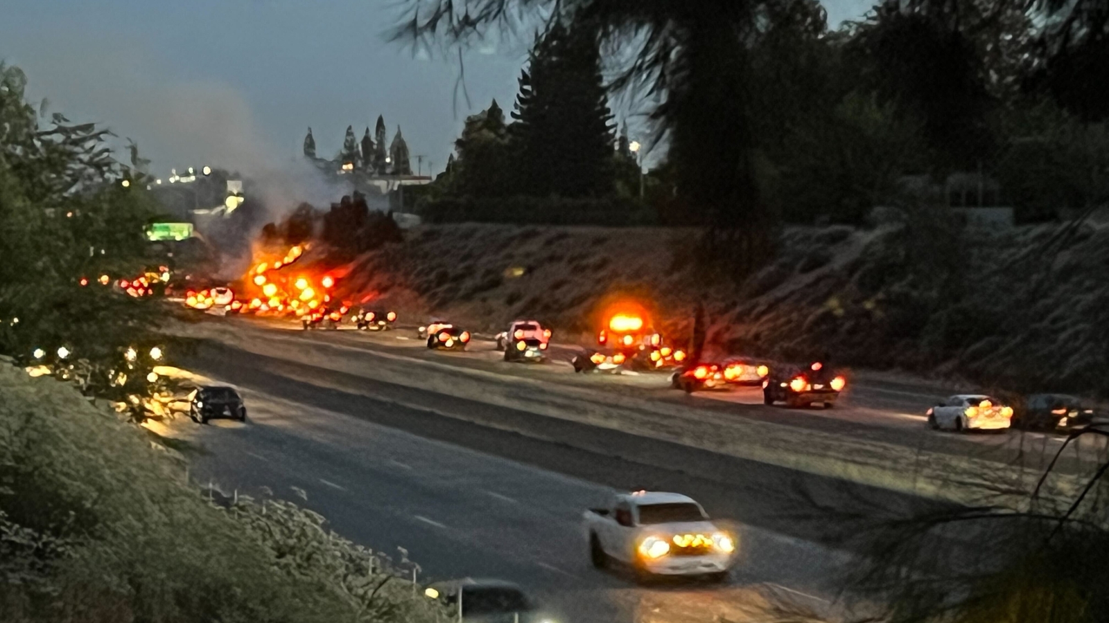 Firefighters working to contain grass fire along Highway 41 in Fresno