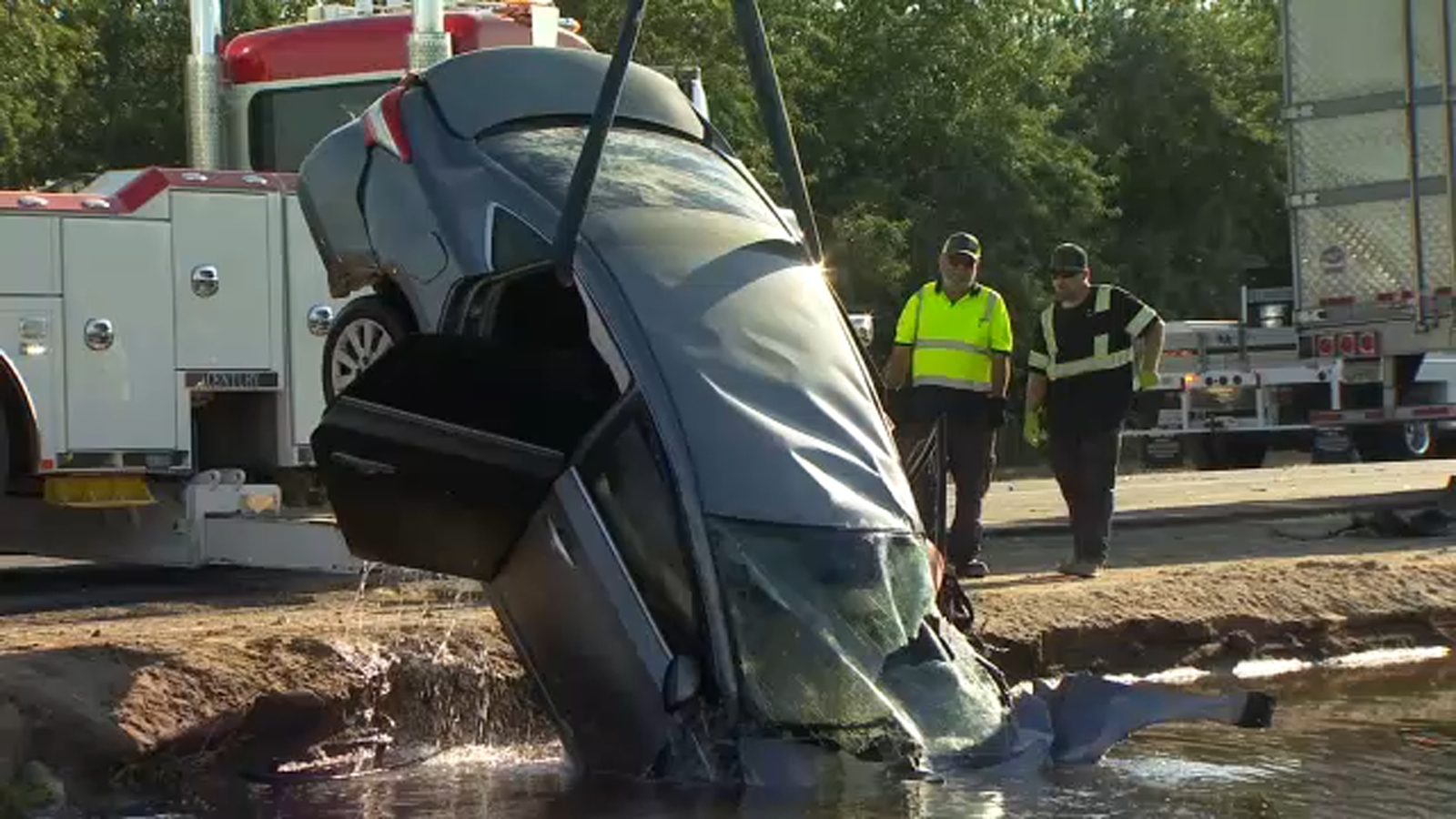 Man's car hit by semi-truck then lands in canal in Fresno County, CHP says