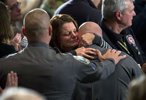 Residents greet each other before the start of an interfaith vigil for the victims of the Sandy Hook Elementary School shooting on Sunday, Dec. 16, 2012, at Newtown High School in Newtown, Conn. A gunman walked into the elementary school Friday and opened fire, killing 26 people, including 20 children. President Barack Obama is scheduled to speak during the vigil. (AP Photo/ Evan Vucci)