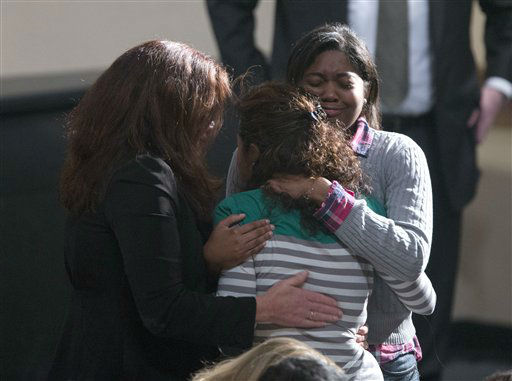 Residents greet each other before the start of an interfaith vigil for the victims of the Sandy Hook Elementary School shooting on Sunday, Dec. 16, 2012 at Newtown High School in Newtown, Conn. A gunman walked into Sandy Hook Elementary School Friday and opened fire, killing 26 people, including 20 children. (AP Photo/Evan Vucci)