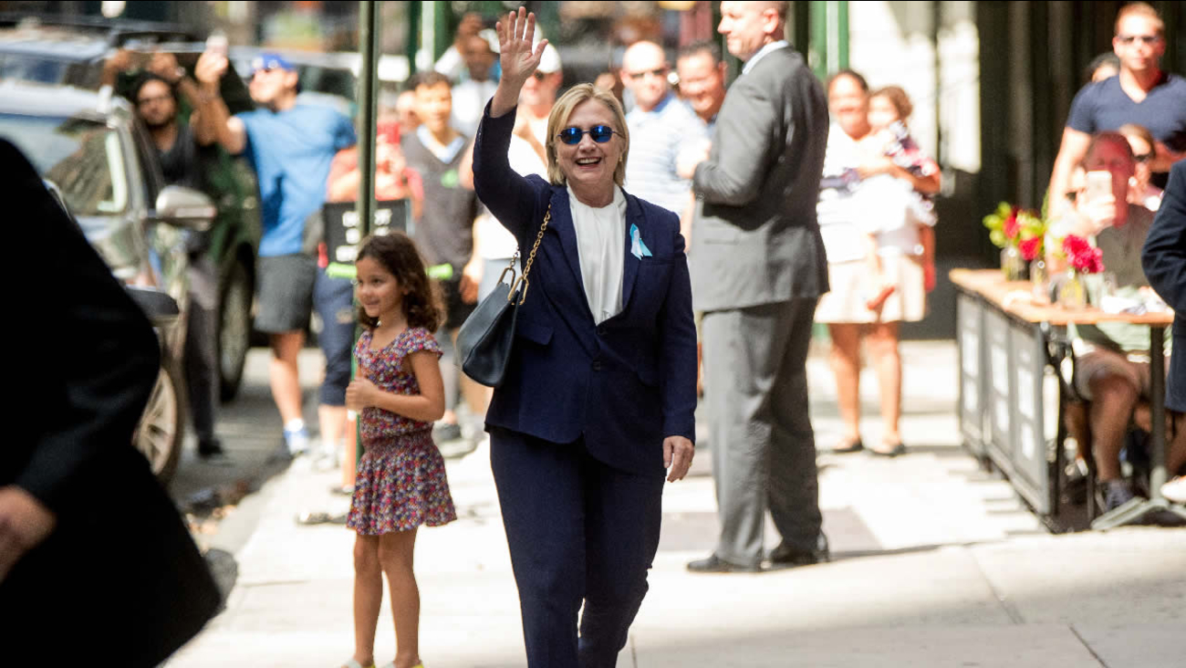Democratic presidential candidate Hillary Clinton waves after leaving an apartment building Sunday, Sept. 11, 2016, in New York. 