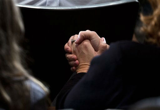 Residents look on as President Barack Obama delivers remarks at an interfaith vigil for the victims of the Sandy Hook Elementary School shooting on Sunday, Dec. 16, 2012, at Newtown High School in Newtown, Conn. A gunman walked into the elementary school Friday and opened fire, killing 26 people, including 20 children. (AP Photo/ Evan Vucci)