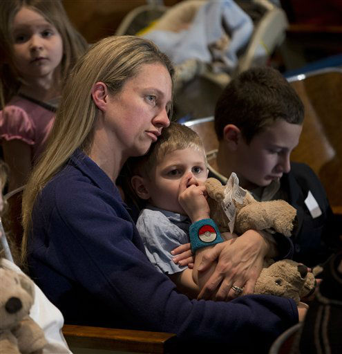 Residents wait for the start of an interfaith vigil for the victims of the Sandy Hook Elementary School shooting on Sunday, Dec. 16, 2012 at Newtown High School in Newtown, Conn. A gunman walked into Sandy Hook Elementary School Friday and opened fire, killing 26 people, including 20 children. (AP Photo/Evan Vucci)