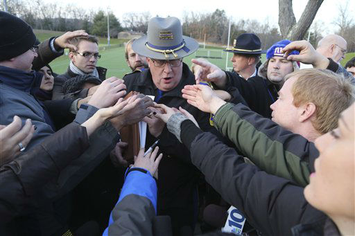 Lt. J. Paul Vance of the Connecticut State Police is surrounded by reporters as he hands out the list of victims of the shooting at the Sandy Hook Elementary School, Saturday, Dec. 15, 2012 in Sandy Hook village of Newtown, Conn. The victims of the shooting were shot multiple times by semiautomatic rifle, according to Connecticut Chief Medical Examiner H. Wayne Carver II, M.D. Carver called the injuries "devastating" and the worst he and colleagues had ever seen. Police began releasing the identities of the dead. All of the 20 children killed were 6 or 7 years old. Carver, said he examined seven of the children killed, and two had been shot at close range. When asked how many bullets were fired, he said, "I'm lucky if I can tell you how many I found." (AP Photo/Mary Altaffer)
