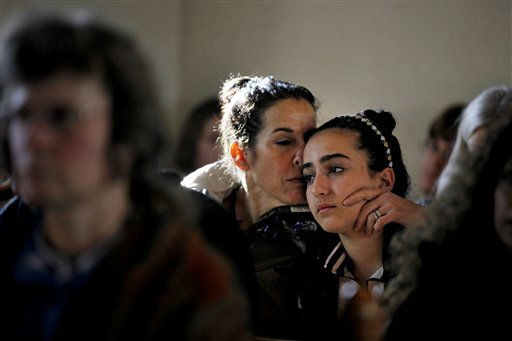 Elizabeth Bogdanoff, left, kisses her daughter Julia, 13, both of Newtown, Conn., during a prayer service at St John's Episcopal Church, Saturday, Dec. 15, 2012, in Newtown, Conn. The massacre of 26 children and adults at Sandy Hook Elementary school elicited horror and soul-searching around the world even as it raised more basic questions about why the gunman, 20-year-old Adam Lanza, would have been driven to such a crime and how he chose his victims. (AP Photo/David Goldman)