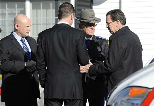 Gov. Dannel P. Malloy, right, talks with officials at a staging area following a shooting at the Sandy Hook Elementary School in Newtown, Conn. where authorities say a gunman opened fire, leaving 27 people dead, including 20 children, Friday, Dec. 14, 2012. (AP Photo/Jessica Hill)