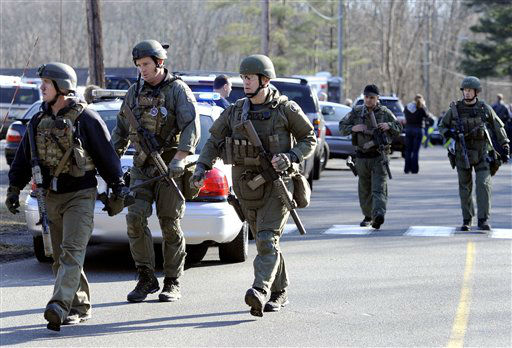 State Police are on scene following a shooting at the Sandy Hook Elementary School in Newtown, Conn. where authorities say a gunman opened fire, leaving 27 people dead, including 20 children, Friday, Dec. 14, 2012. (AP Photo/Jessica Hill)