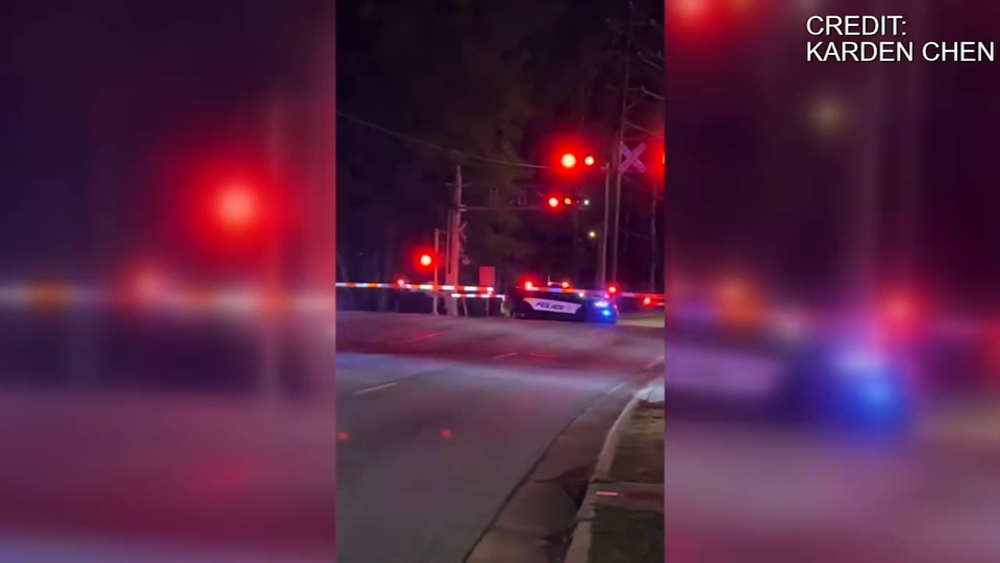 NC officer gets out of car on train tracks before it's hit by Amtrak