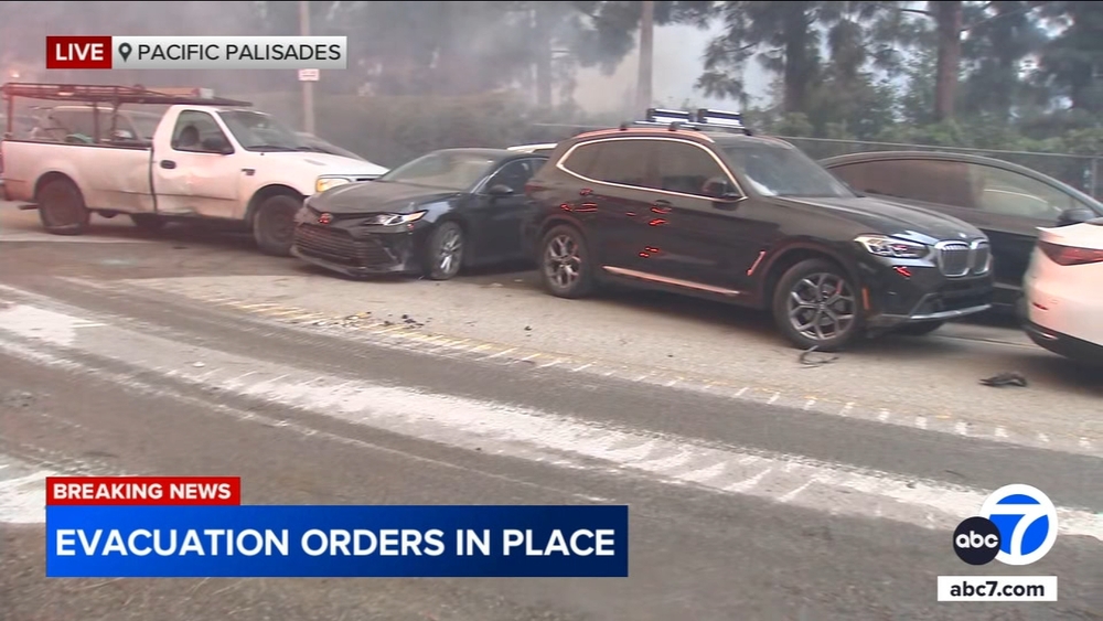 Hundreds of abandoned cars on Sunset Blvd pushed aside by fire dozer