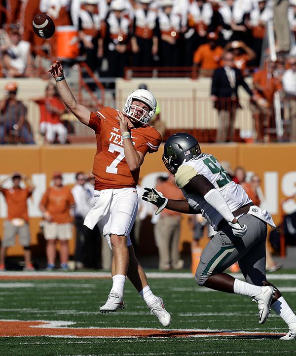 Texas quarterback Shane Buechele (7) is pressured by Baylor defensive tackle Micheal Johnson (92) during the first half on a NCAA college football game.