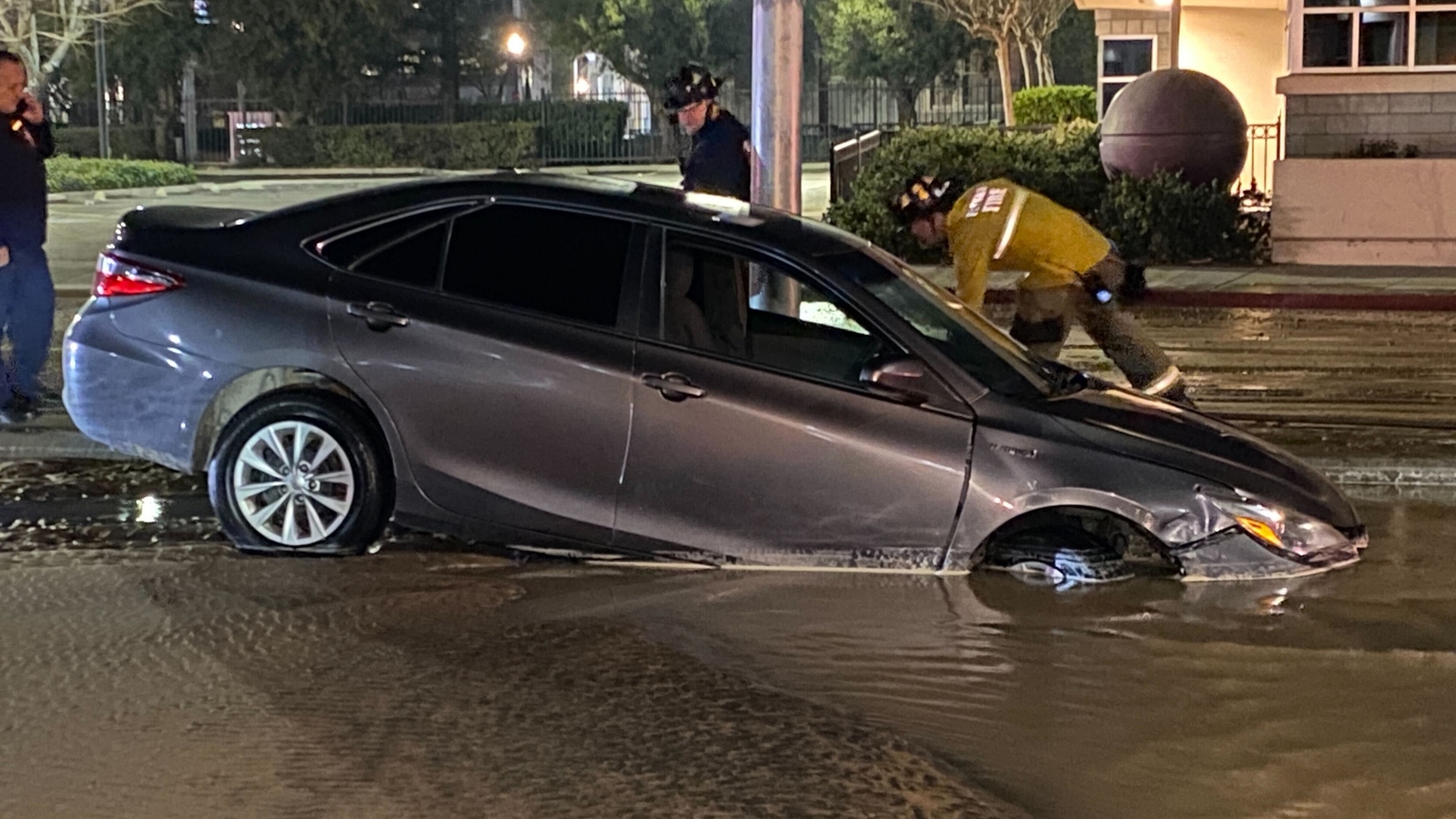 Car falls into sinkhole after water main break in downtown Fresno