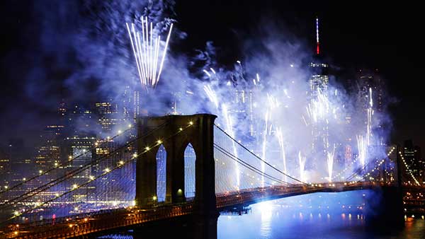 Fireworks light up the sky above the Brooklyn Bridge during Macy's Fourth of July fireworks show on July 4, 2014, in New York.