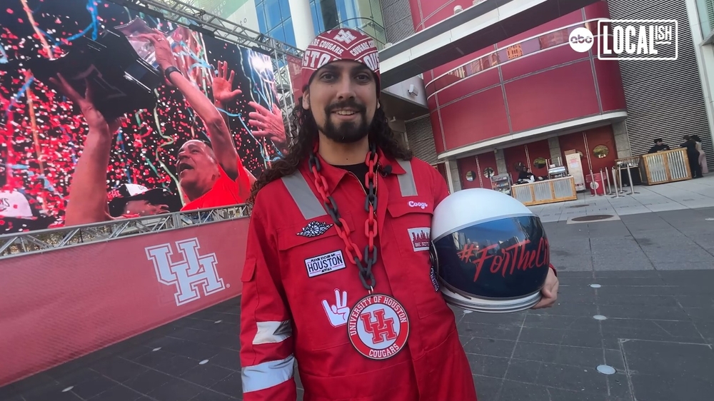 UH superfan cheering on coogs in fun costumes