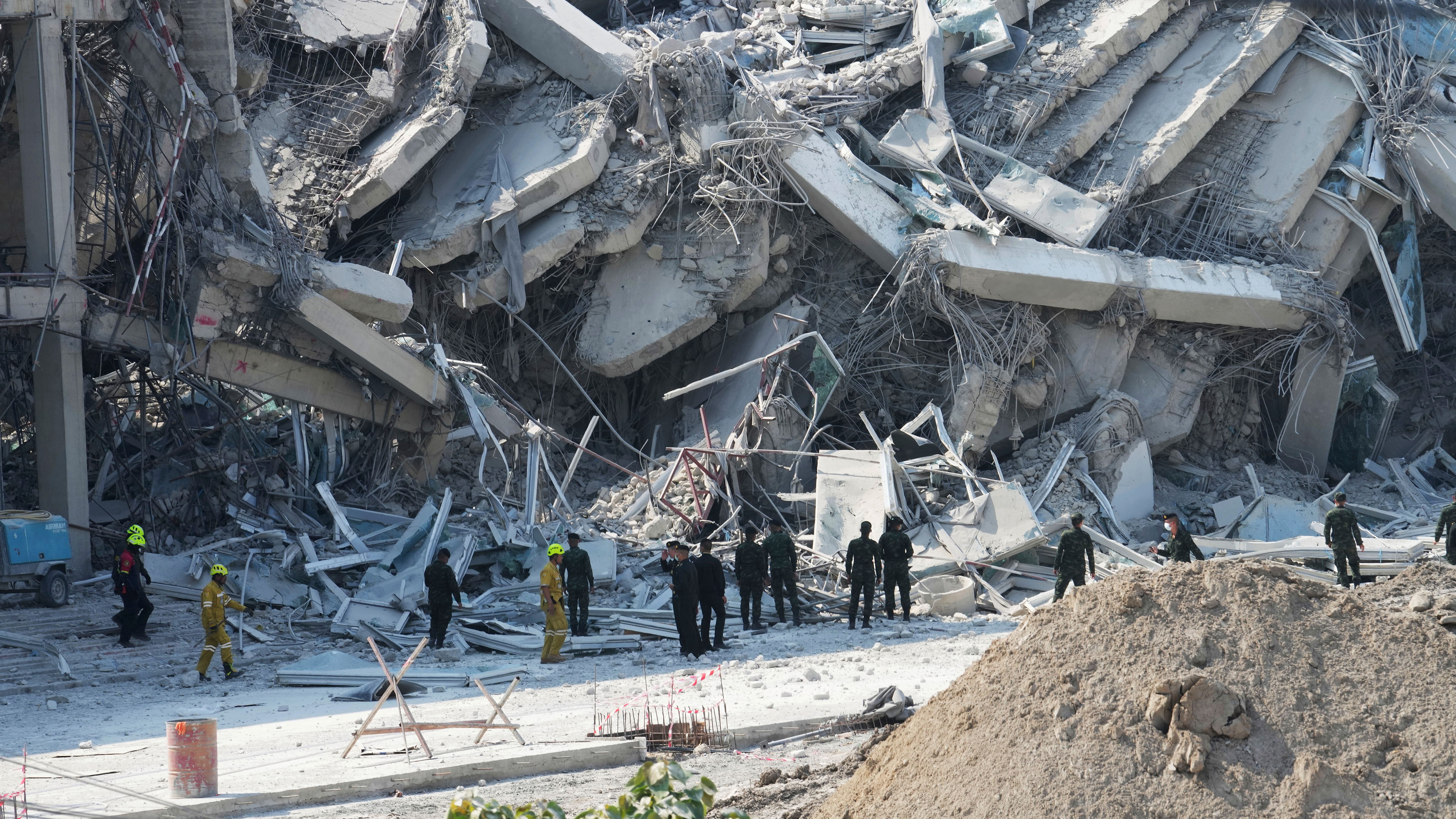 Rescuers work at the site of a high-rise building under construction that collapsed after a 7.7 magnitude earthquake in Bangkok, Thailand, Friday, March 28, 2025.