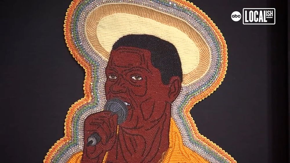 Demond Melancon works with a needle and thread to make beaded pieces.