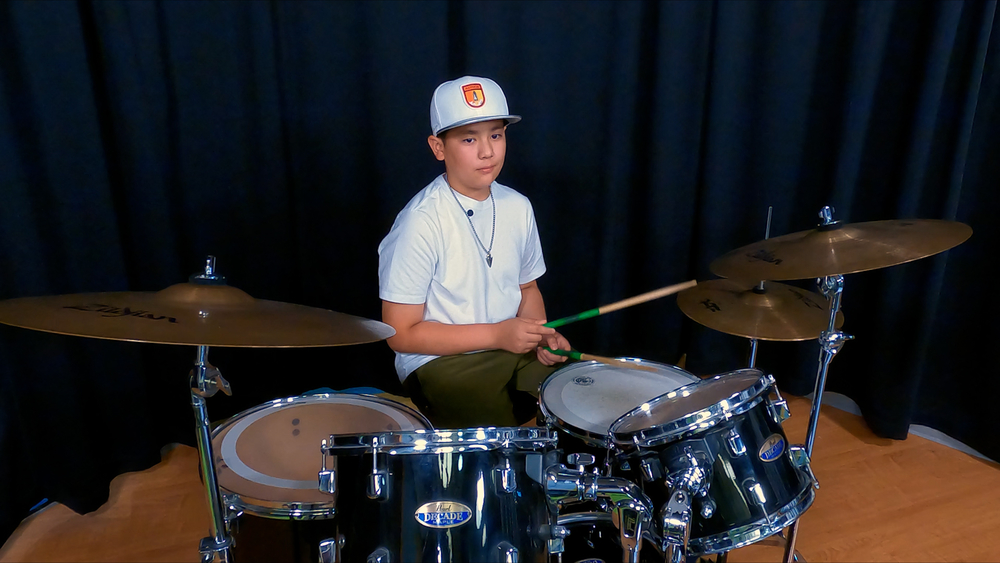 Paralyzed by rare disease, young drummer makes comeback