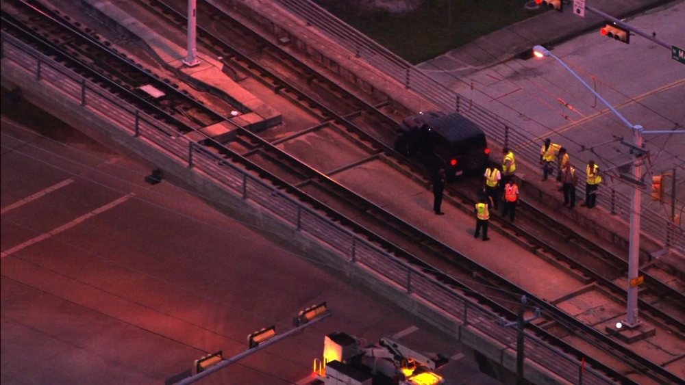 Jeep gets stuck on METRORail tracks overpass near downtown