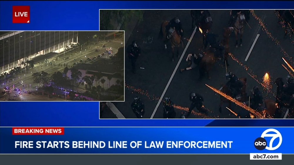 Fire erupts behind line of law enforcement during LAPD press briefing
