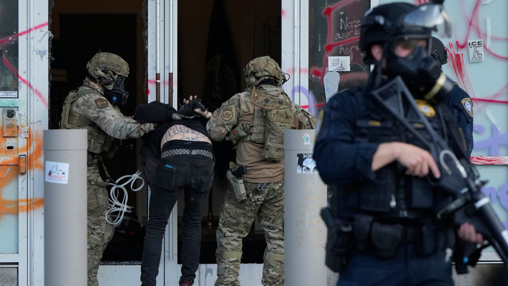U.S. Customs and Border Protection agents detain a man outside the U.S. Immigration and Customs building during a protest in Portland, Ore., June 14, 2025.