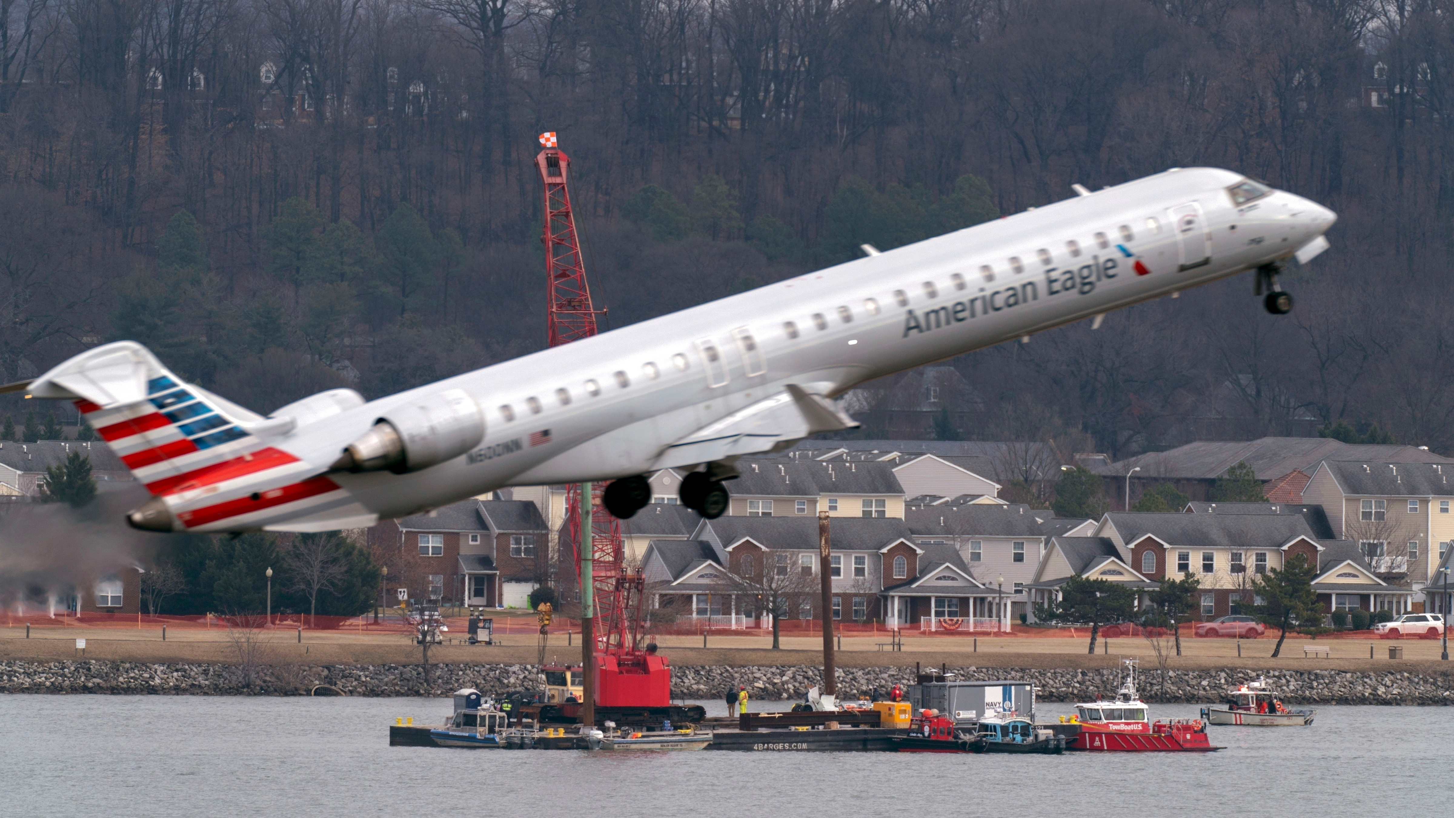 Salvage crews work on recovering wreckage near the site in the Potomac River of a mid-air collision between an American Airlines jet and a Black Hawk helicopter at Ronald Reagan Washington National Airport, Thursday, Feb. 6, 2025, in Arlington, Va.