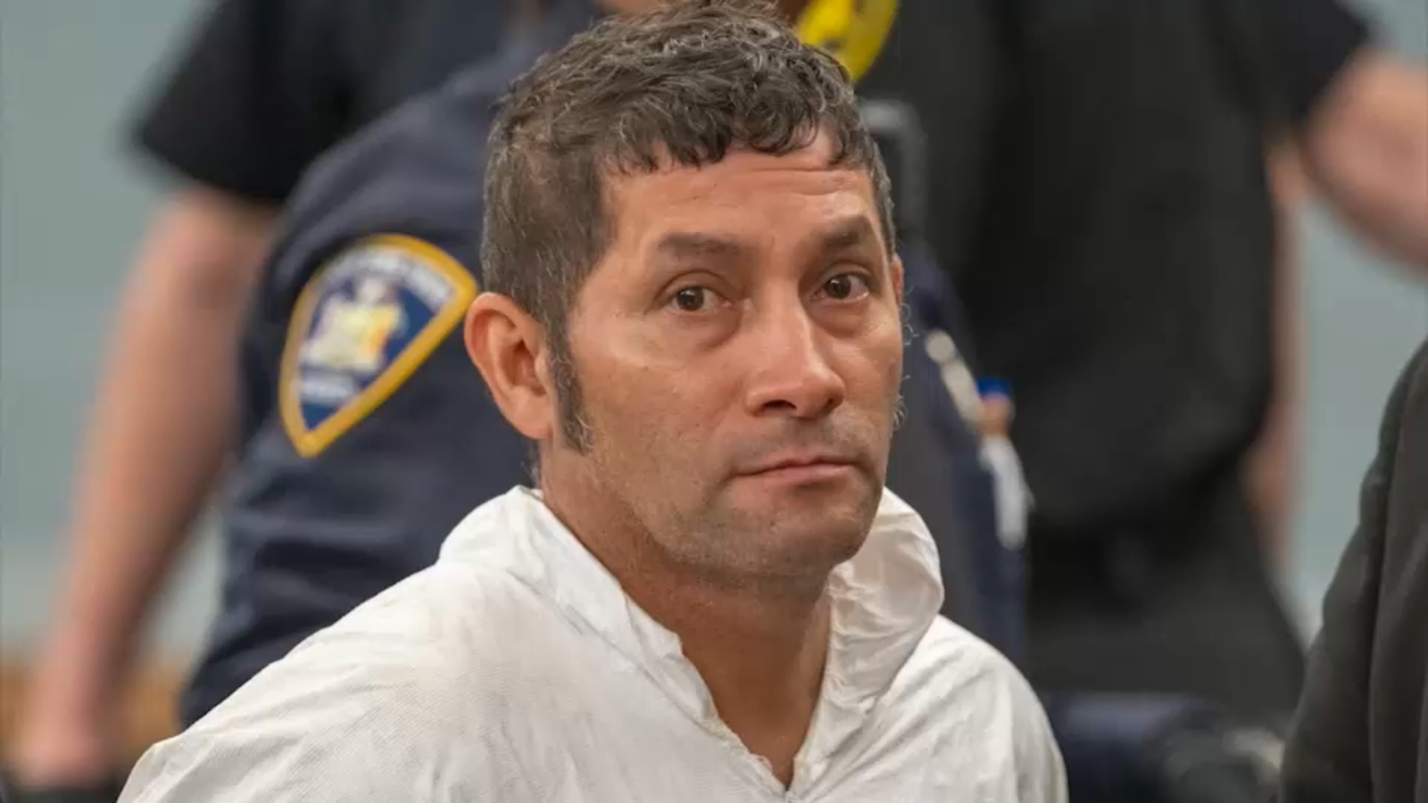 Man pleads not guilty to killing coworker with machete, shooting New York officer in face