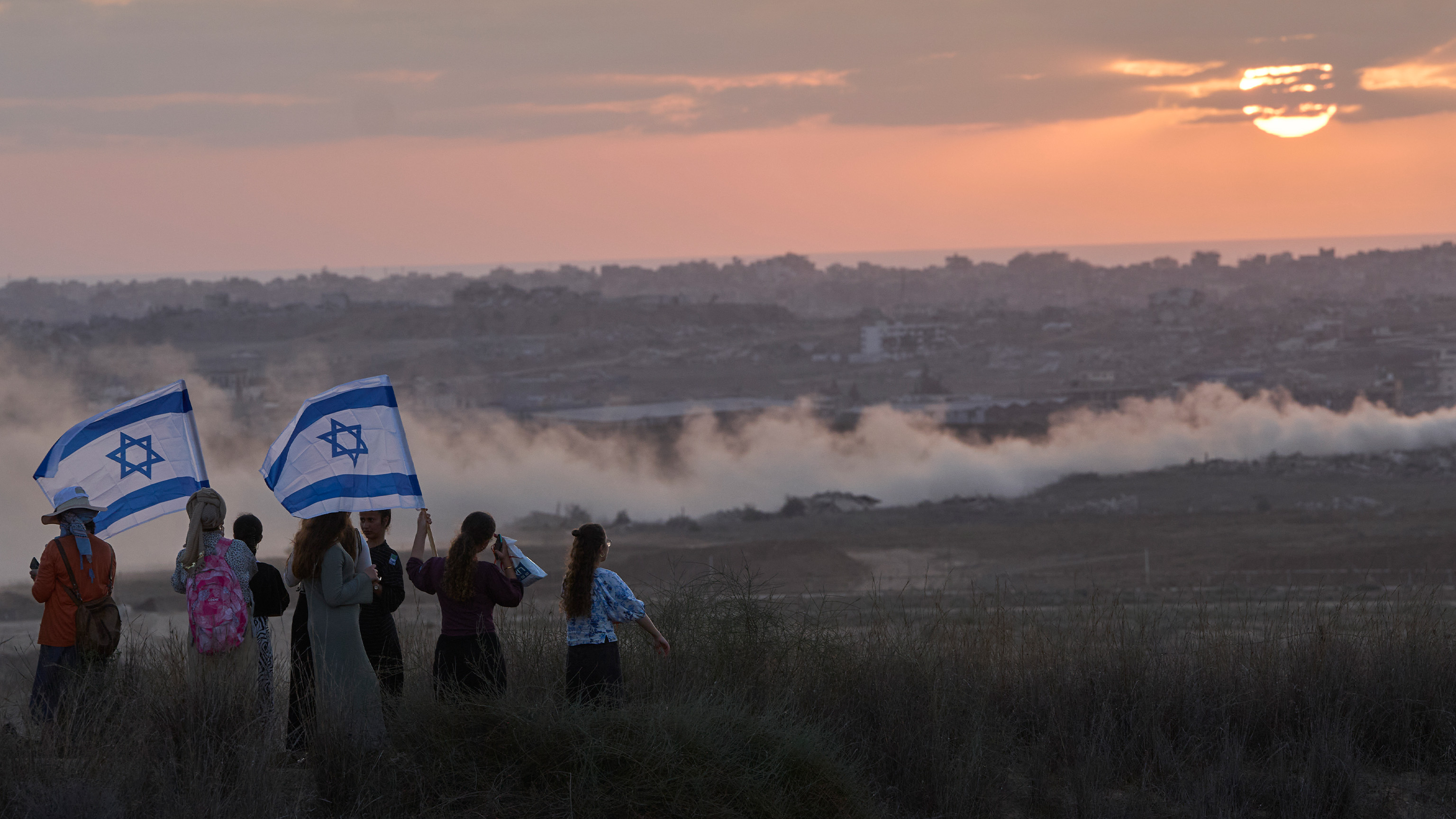 Israeli right-wing activists watch the northern Gaza Strip during a rally calling for the re-establishment of Jewish settlements in the Gaza Strip, near the border in southern Israel, Wednesday, July 30, 2025.