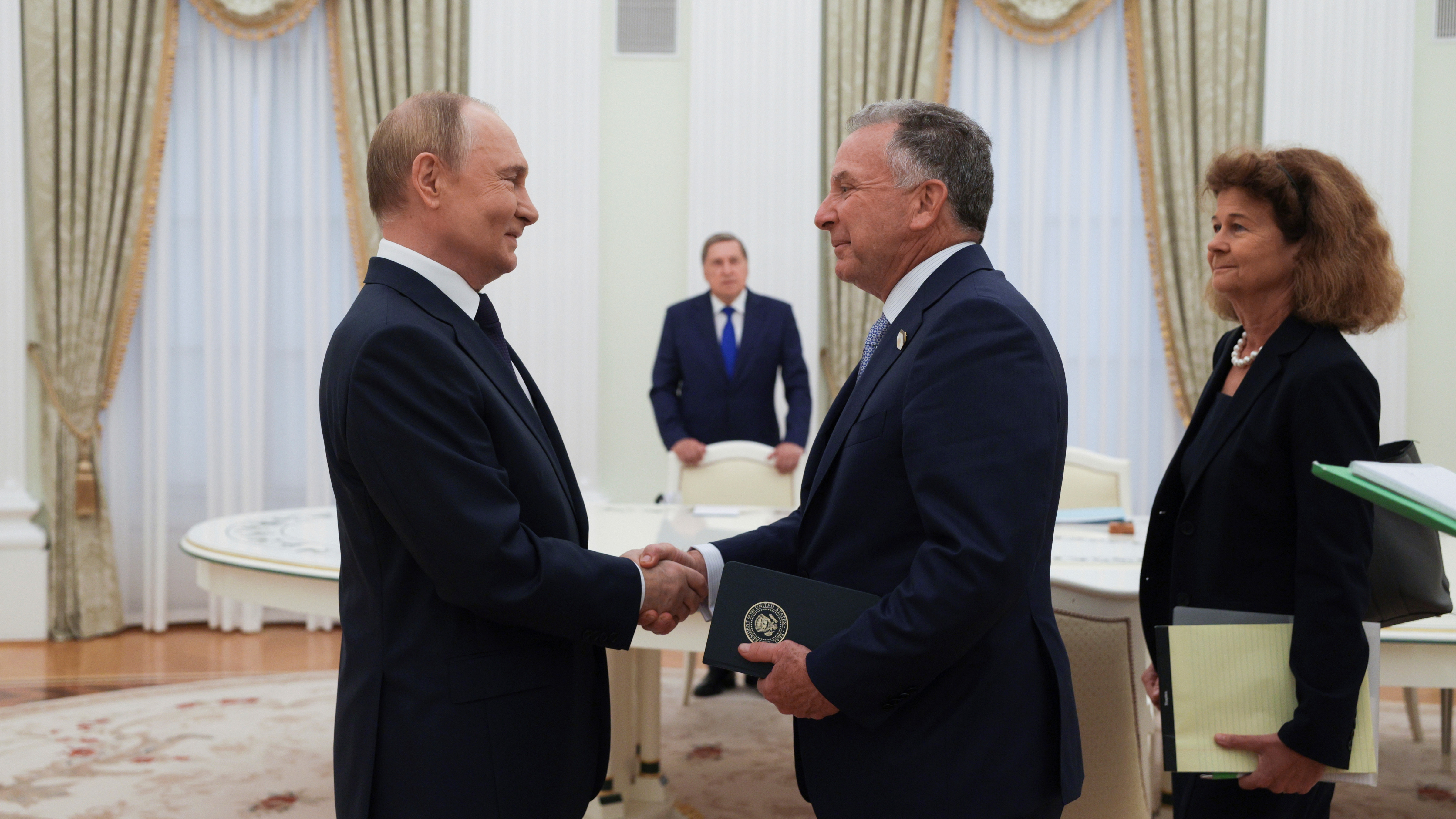 Russian President Vladimir Putin, left, and U.S. President Donald Trump's special envoy Steve Witkoff, right, shake hands during their meeting at the Kremlin in Moscow, Russia, Wednesday, Aug. 6, 2025.
