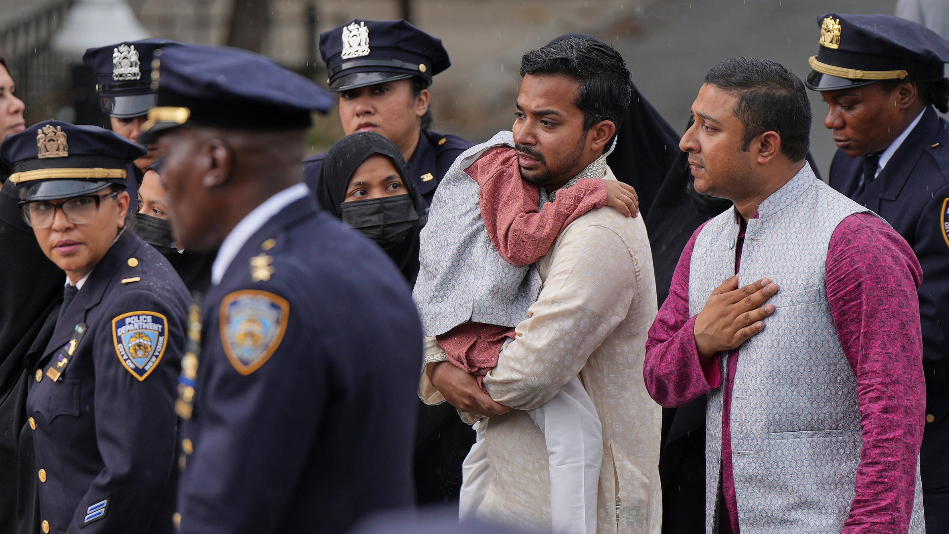 Family members of NYPD officer Didarul Islam walk in a procession after his funeral, Thursday, July 31, 2025, in New York.