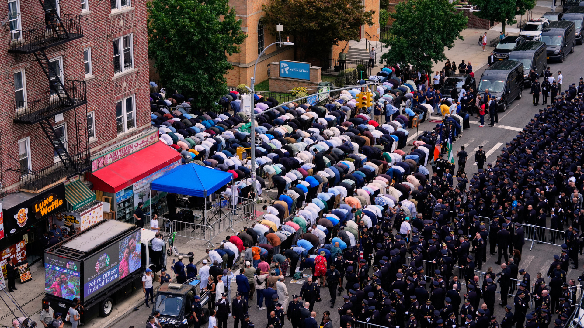 Muslims pray in the street outside the mosque during the funeral for NYPD officer Didarul Islam, Thursday, July 31, 2025, in New York.