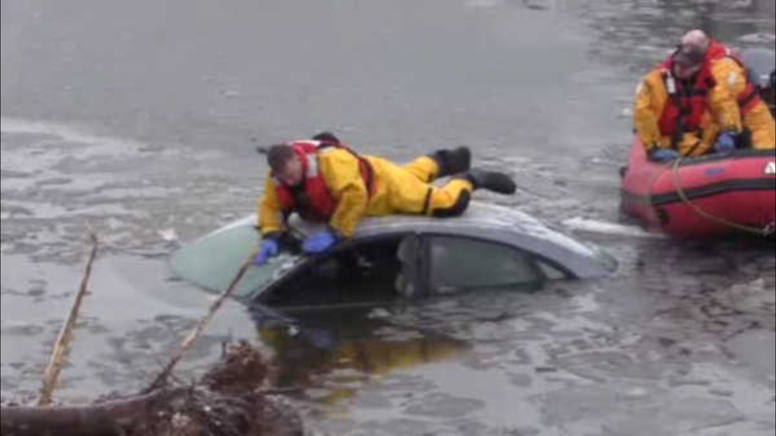 Good Samaritans, police rescue woman trapped in car sinking in icy pond