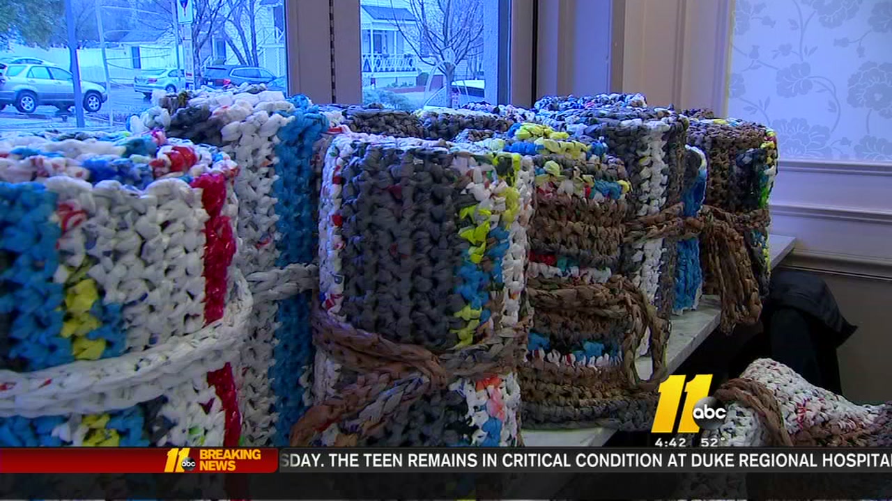 Group crocheting mats for refugees