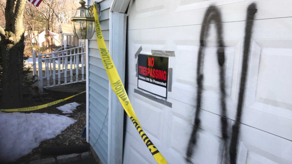 Inter-racial couple finds racist graffiti on garage door
