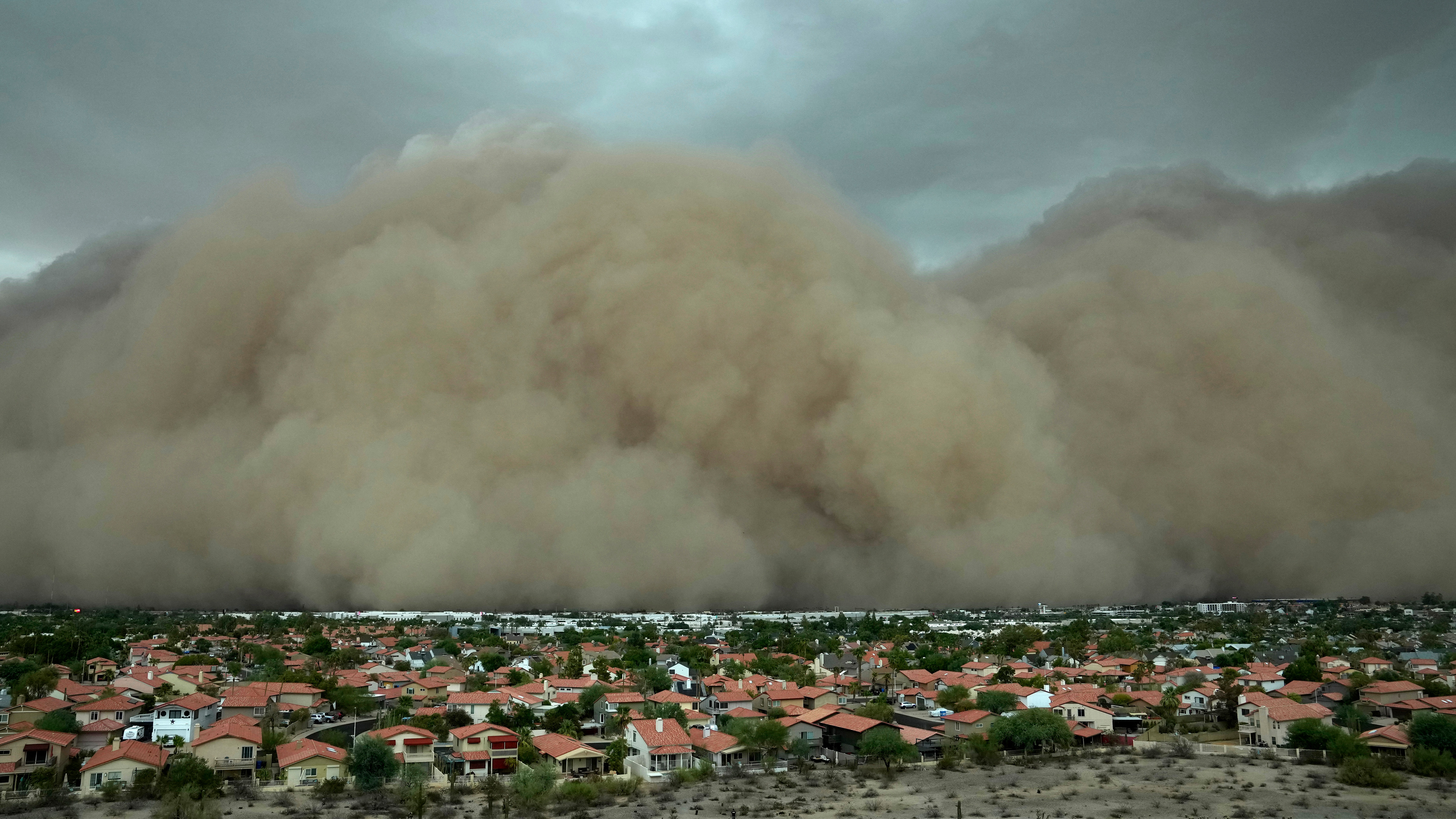 A giant dust storm approaches the Phoenix metro area as a monsoon storm pushes the dust into the air, Monday, Aug. 25, 2025, in Phoenix.
