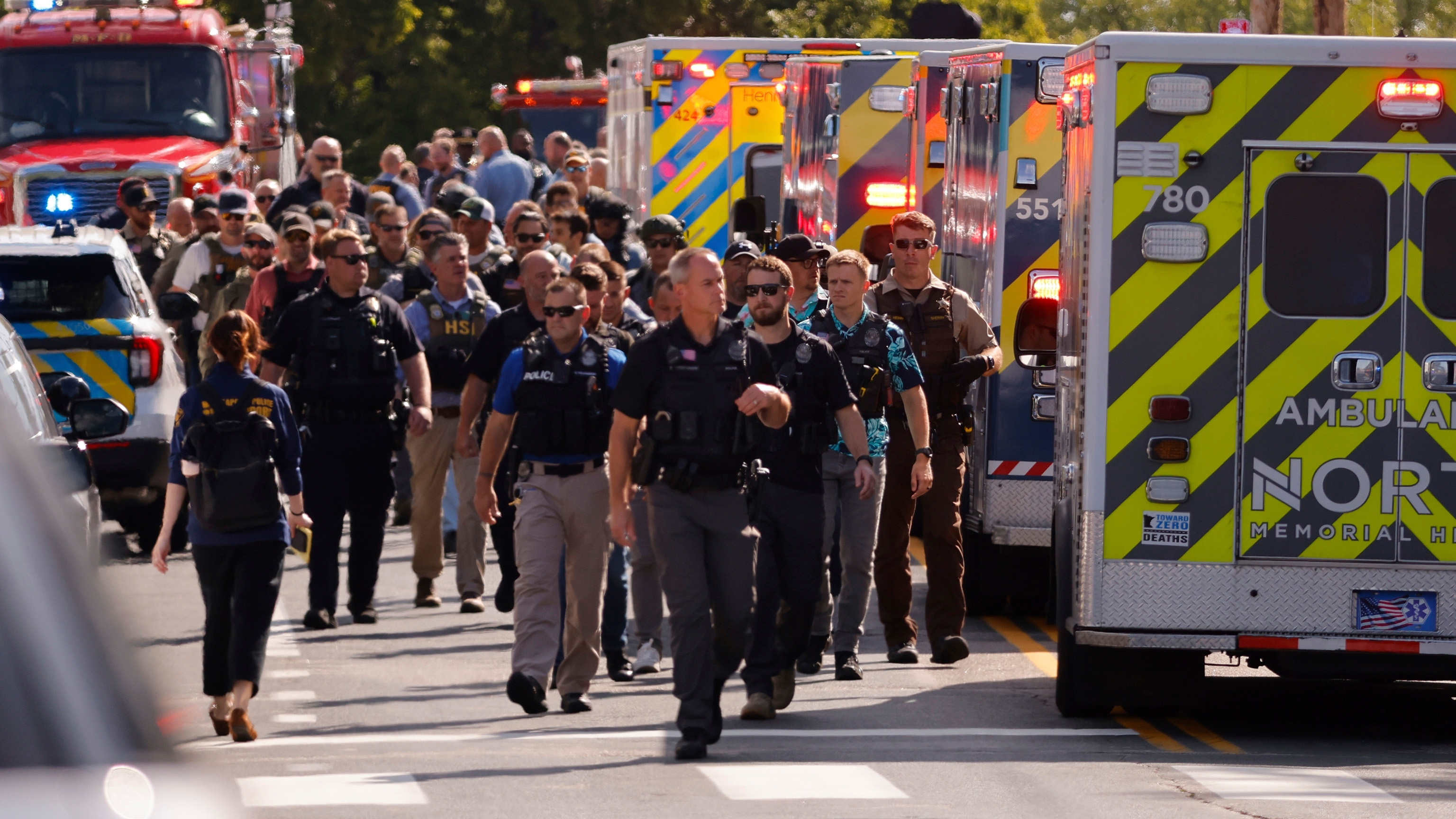 Law enforcement officers gather outside the Annunciation Church's school in response to a reported mass shooting, Wednesday, Aug. 27, 2025, in Minneapolis.