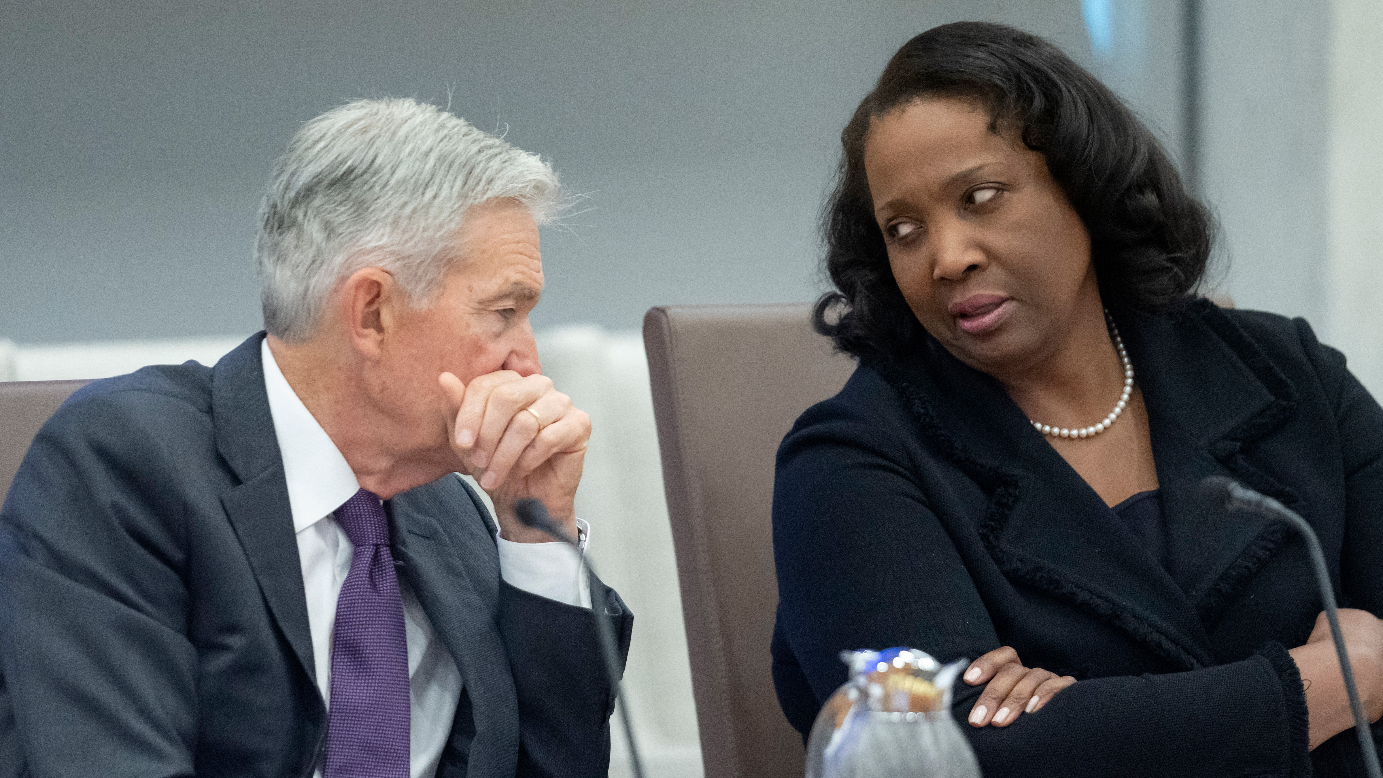 Federal Reserve Chairman Jerome Powell, left, talks with Board of Governors member Lisa Cook, right, during an open meeting of the Board of Governors at the Federal Reserve, June 25, 2025, in Washington.