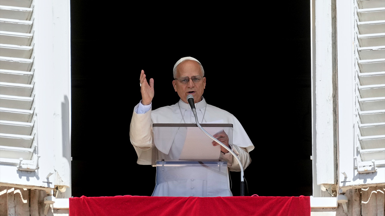 Pope Leo XIV delivers his blessing as he recites the Angelus noon prayer from the window of his studio overlooking St.Peter's Square, at the Vatican, Sunday, Aug. 31, 2025.
