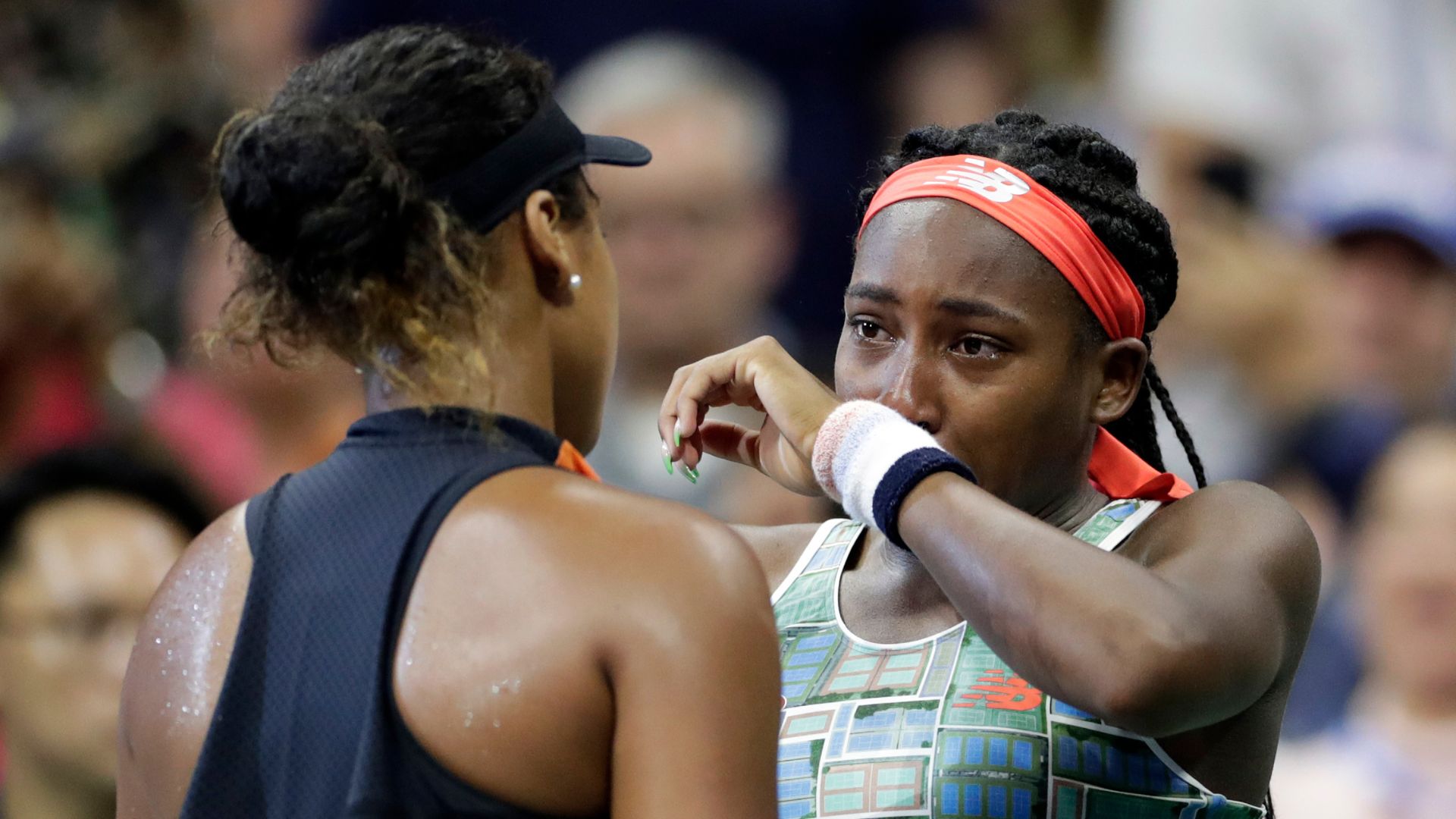 Coco Gauff, right, of the U.S., wipes away tears while talking to Naomi Osaka, of Japan. Osaka defeated Gauff in the third round of the U.S. Open tennis tournament, Aug. 31, 2019.