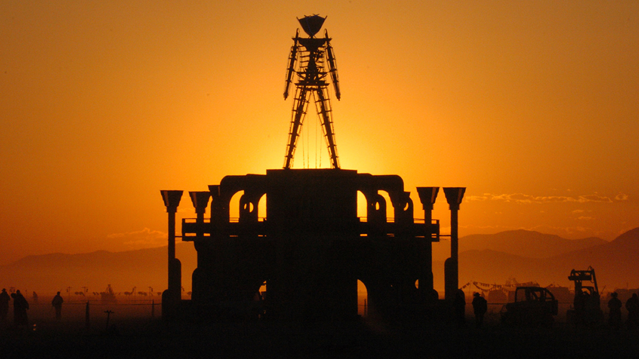 The Man, a stick figured symbol of the Burning Man art festival, is silhouetted against a morning sunrise in this file photo from Sept. 2, 2006, at the festival in Nevada's Black Rock Desert.