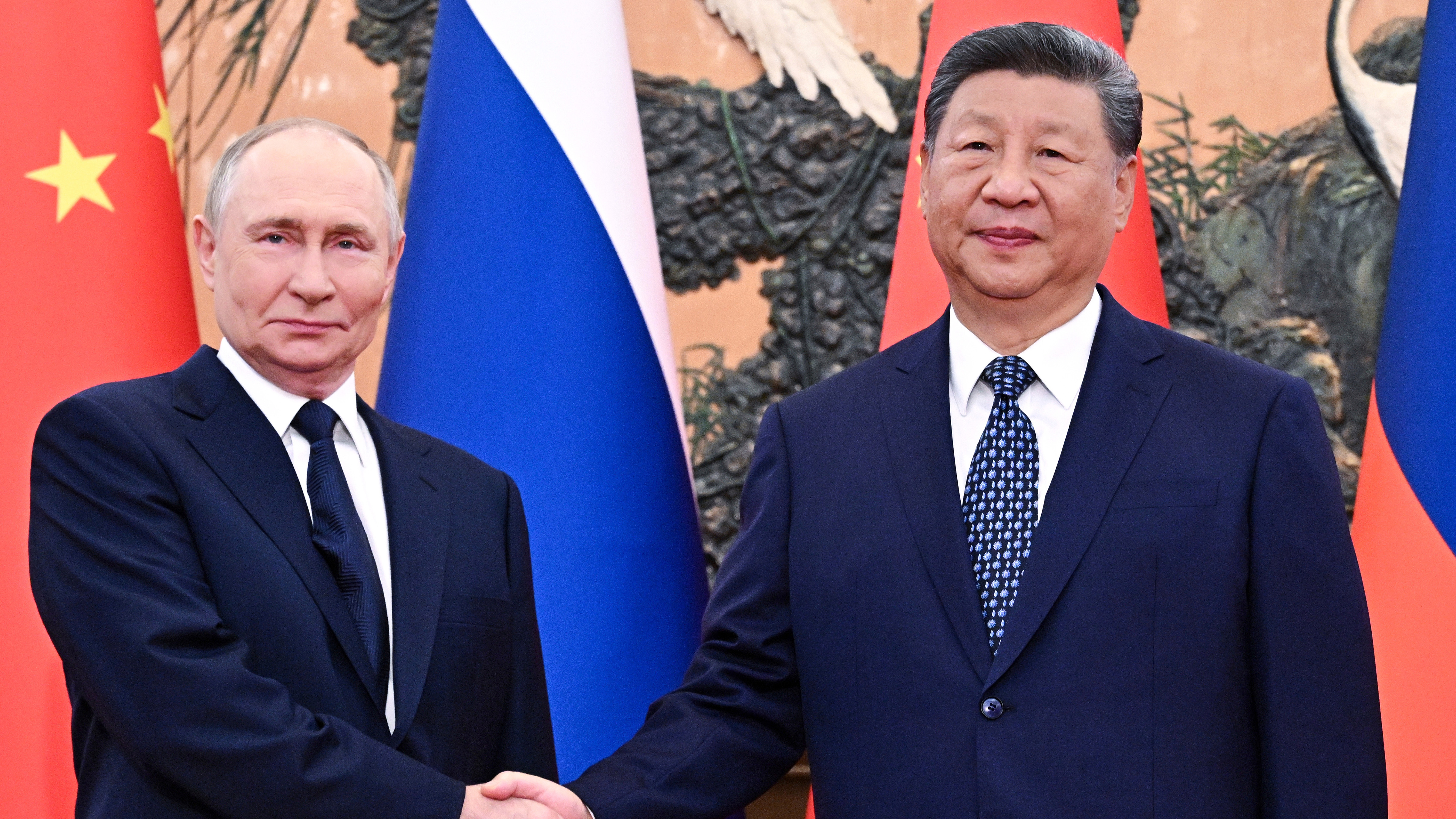 Russian President Vladimir Putin, left, and Chinese President Xi Jinping shake hands ahead of their meeting at The Great Hall of the People in Beijing, China, Tuesday, Sept. 2, 2025.